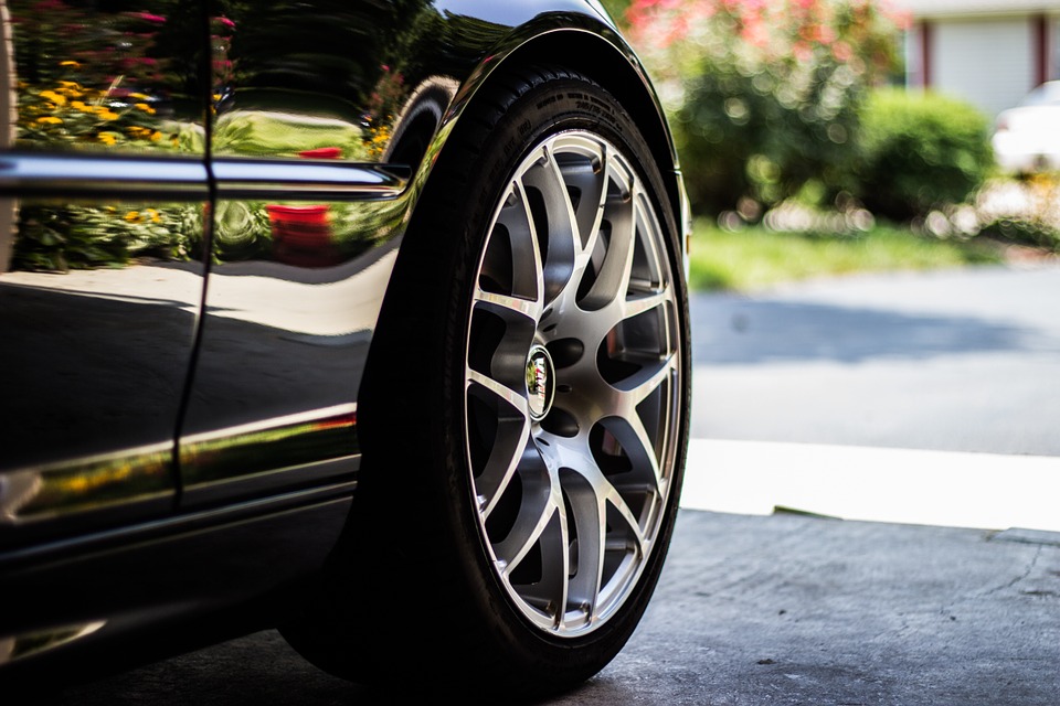 Silver alloy wheel of a black car
