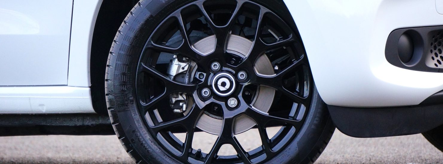 Black rim of a white car