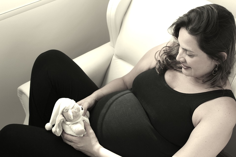 Pregnant woman sitting on the couch