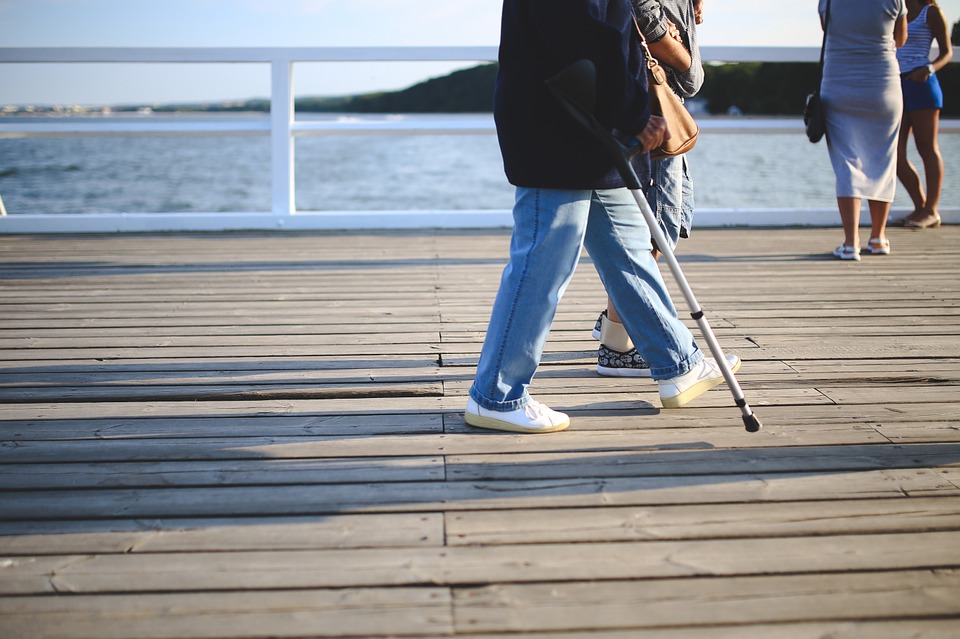 People standing in walkway besides the ocean