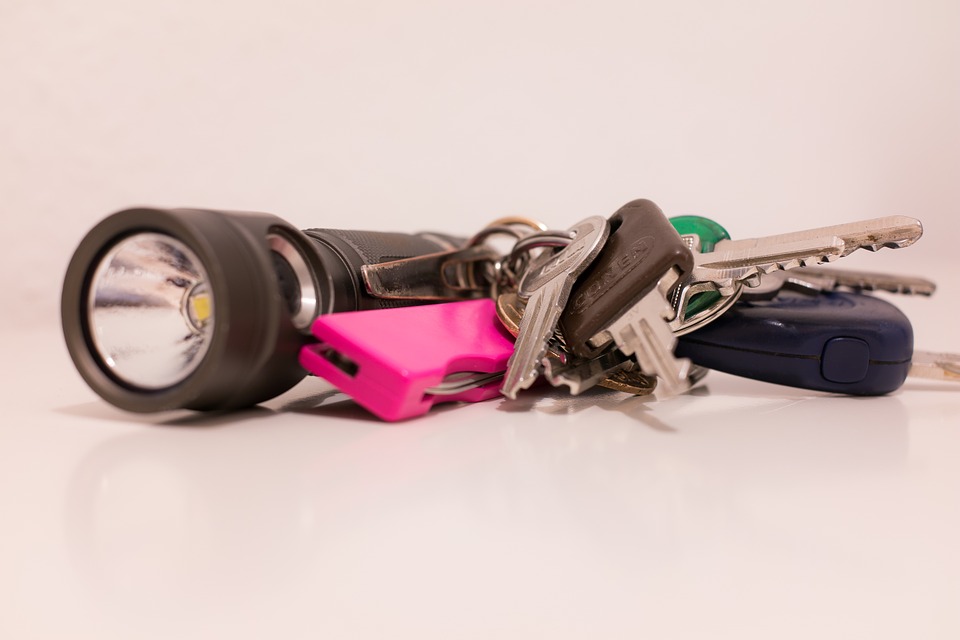 Flashlight and keys on top of the table
